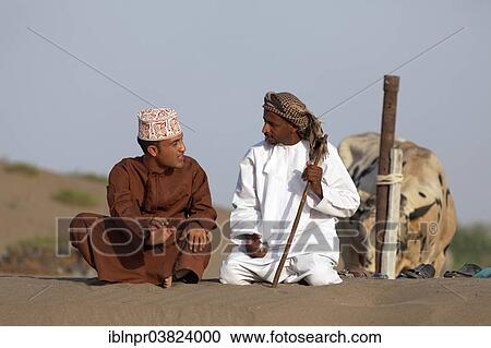 "Omanis talking while sitting in traditional clothing, Barka, Al-Batinah province, Oman, Arabian Peninsula, Asia" View Large Photo Image Stock Image - "Omanis talking while sitting in traditional clothing, Barka, Al-Batinah province, Oman, Arabian Peninsula, Asia". Fotosearch