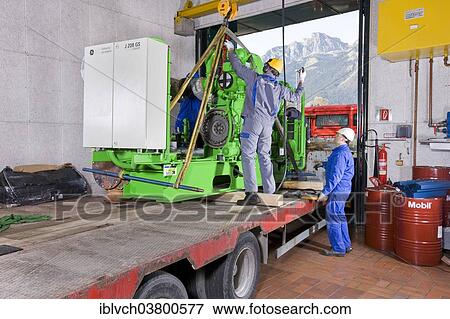"On-site service at GE Energy, gas engine to generate electricity is exchanged and repaired after reaching specified operating hours, a serviced engine is being delivered, Strass sewage works in Zillertal Valley, North Tyrol, Austria, Europe" View Large Photo Image Stock Photo - "On-site service at GE Energy, gas engine to generate electricity is exchanged and repaired after reaching specified operating hours, a serviced engine is being delivered, Strass sewage works in Zillertal Valley, North Tyrol, Austria, Europe". Fotosearch
