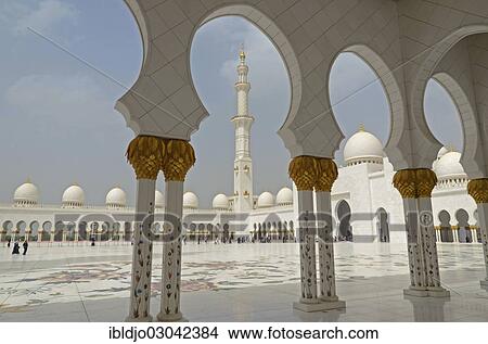 Picture - "One of the four minarets of Sheikh Zayed Grand Mosque, seen though an arch of the archway surrounding its courtyard, Abu Dhabi, Emirate of Abu Dhabi, United Arab Emirates, Asia". Fotosearch