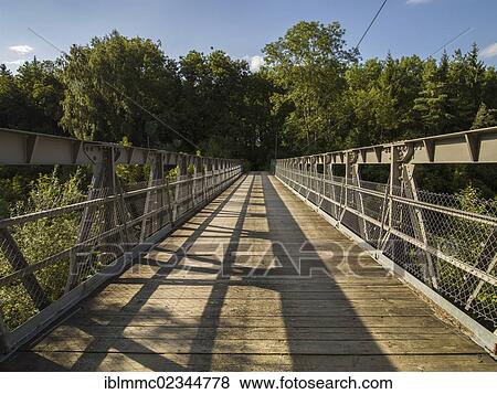 Stock Photo - "Only steel bridge with wooden planks crossing the Wertach River, Mittelstetten, Bavaria, Germany, Europe". Fotosearch