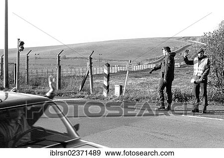 Stock Photo - "Open inner-German border between Lower Saxony and the district of Erfurt, Thuringia, in the morning after the opening of the border was announced, GDR citizens leaving on the road from Worbis to Duderstadt, Duderstadt, Lower Saxony, Germany, Europe". Fotosearch