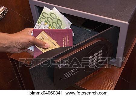 "Open safe, hand holding credit card, passport and cash, in a hotel room" View Large Photo Image Stock Image - "Open safe, hand holding credit card, passport and cash, in a hotel room". Fotosearch