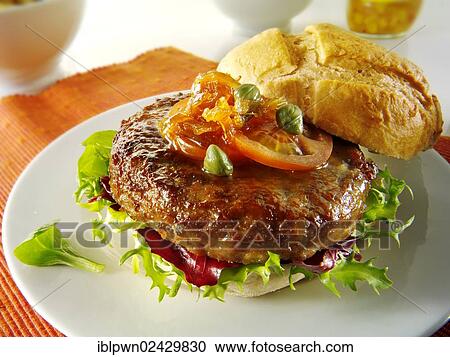 Organic beef burger with tomato relish and salad in a bun View Large Photo Image Stock Image - Organic beef burger with tomato relish and salad in a bun. Fotosearch