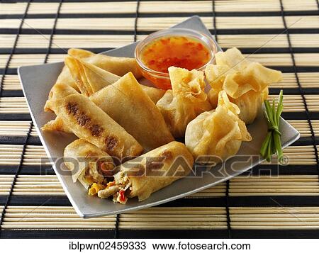 "Oriental selection with dim sum, spring rolls with chicken and vegetables and vegetable samosas with a chili dipping sauce" View Large Photo Image Stock Image - "Oriental selection with dim sum, spring rolls with chicken and vegetables and vegetable samosas with a chili dipping sauce". Fotosearch