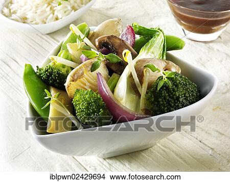 Picture - "Oriental vegetarian stir fry of vegetables, noodles and mushrooms". Fotosearch