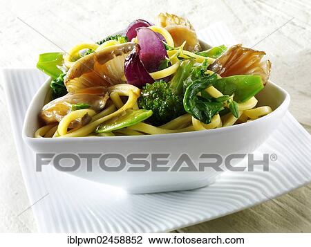 Stock Image - "Oriental vegetarian stir fry of vegetables, noodles and mushrooms". Fotosearch