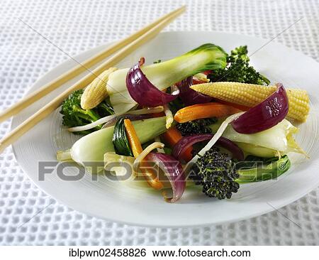 Stock Photograph - "Oriental vegetarian stir fry with rice and chilli dipping sauce, chop sticks". Fotosearch