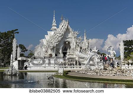 Stock Photography - "Ornate bridge with tourists to the entrance of Wat Rong Khun, White Temple, by architect Chalermchai Kositpipat, Chiang Rai, Chiang Rai Province, Northern Thailand, Thailand, Asia". Fotosearch