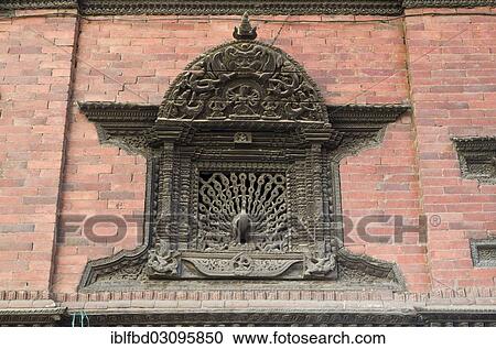 Stock Image - "Ornate carved wooden window with a peacock sculpture, Kathmandu Valley, Kathmandu, Kathmandu District, Bagmati Zone, Nepal, Asia". Fotosearch