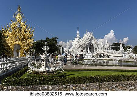 Stock Photography - "Ornate golend entrance of Wat Rong Khun, White Temple, by architect Chalermchai Kositpipat, Chiang Rai, Chiang Rai Province, Northern Thailand, Thailand, Asia". Fotosearch