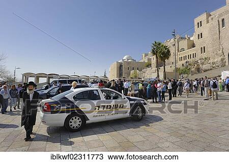 Stock Image - "Orthodox Jew, police car and buildings of the Jewish Quarter at the Wailing Wall or Western Wall, Old City, Jerusalem, Israel, Middle East, Southwest Asia, Asia". Fotosearch