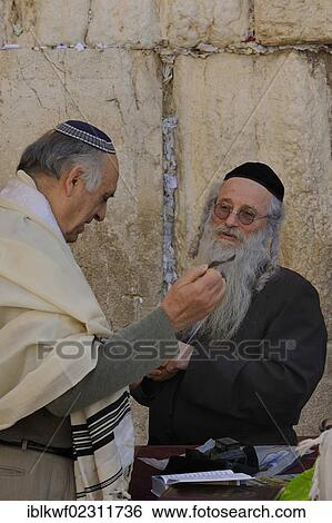 "Orthodox Jews directly in front of the Wailing Wall or Western Wall with tallit, kippah, peyes and side curls, prayer cards are jammed into the crevices of the limestones, Muslim Quarter, Jerusalem, Israel, Middle East, Southwest Asia, Asia" View Large Photo Image Stock Photograph - "Orthodox Jews directly in front of the Wailing Wall or Western Wall with tallit, kippah, peyes and side curls, prayer cards are jammed into the crevices of the limestones, Muslim Quarter, Jerusalem, Israel, Middle East, Southwest Asia, Asia". Fotosearch