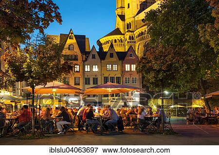Stock Photo - "Outdoor cafes in Fischmarkt square with Great St. Martin Church in the evening, historic centre, Cologne, North Rhine-Westphalia, Germany, Europe". Fotosearch