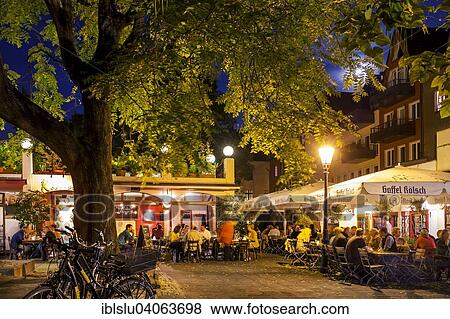 "Outdoor cafes in the historic centre in the evening, Cologne, North Rhine-Westphalia, Germany, Europe" View Large Photo Image Stock Photo - "Outdoor cafes in the historic centre in the evening, Cologne, North Rhine-Westphalia, Germany, Europe". Fotosearch