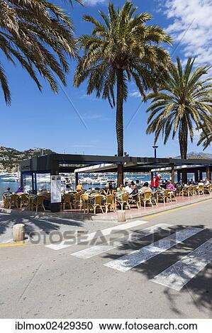 "Outdoor restaurants with tourists in the bay of Puerto Andratx, Port d'Andratx, Mallorca, Balearic Islands, Spain, Europe" View Large Photo Image Stock Image - "Outdoor restaurants with tourists in the bay of Puerto Andratx, Port d'Andratx, Mallorca, Balearic Islands, Spain, Europe". Fotosearch