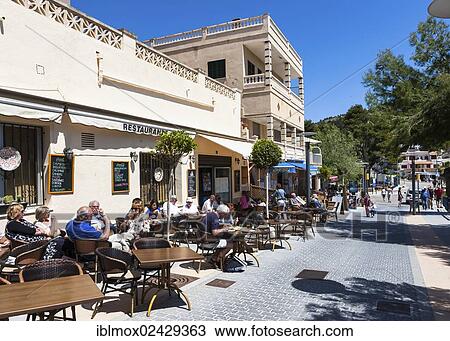 "Outdoor restaurants with tourists in Sant Elm, municipality of Andratx, Sant Elm, Mallorca, Balearic Islands, Spain, Europe" View Large Photo Image Stock Image - "Outdoor restaurants with tourists in Sant Elm, municipality of Andratx, Sant Elm, Mallorca, Balearic Islands, Spain, Europe". Fotosearch