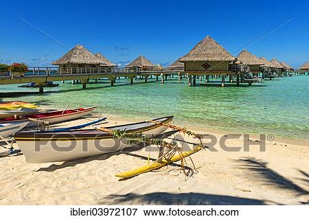 Stock Photo - "Outrigger boats on the beach, overwater bungalows, Bora Bora, French Polynesia, Oceania". Fotosearch