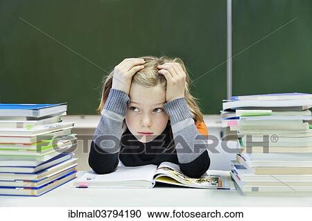 "Overburdened schoolgirl, 9 years, sitting with two piles of books in front of a blackboard" View Large Photo Image Stock Image - "Overburdened schoolgirl, 9 years, sitting with two piles of books in front of a blackboard". Fotosearch