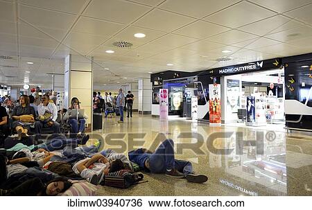 "Overcrowded waiting area, gates, tired passengers, duty-free zone, Madrid Barajas Airport, Madrid, Spain, Europe" View Large Photo Image Stock Photograph - "Overcrowded waiting area, gates, tired passengers, duty-free zone, Madrid Barajas Airport, Madrid, Spain, Europe". Fotosearch