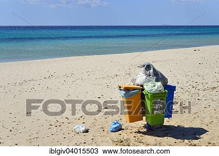 Stock Image - "Overflowing trash cans on the beach, Costa Rei, Cagliari, Sardinia, Italy Province". Fotosearch