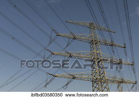 Stock Image - "Overhead powerlines against blue sky, Dresden, Saxony, Germany, Europe". Fotosearch