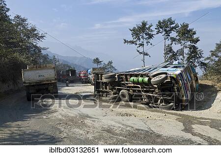 Stock Image - "Overturned truck on the Kathmandu - Pokhara highway, Kathmandu Valley, near Kathmandu, Kathmandu District, Bagmati Zone, Nepal, Asia". Fotosearch