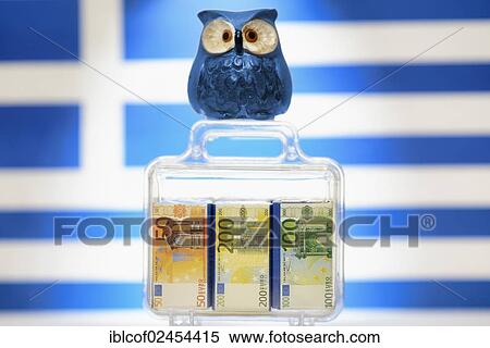 Stock Photography - "Owl on a suitcase full of money in front of a Greek flag, symbolic image for EU aid to Greece". Fotosearch