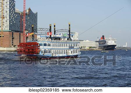 Stock Photography - "Paddle steamer, RMS Queen Mary 2 visiting during Hamburg Cruise Days, Port of Hamburg with the Elbe Philharmonic Hall, left, under construction, Hamburg, Hamburg, Germany, Europe". Fotosearch