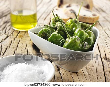 Stock Image - Padron peppers snack with sea salt. Fotosearch