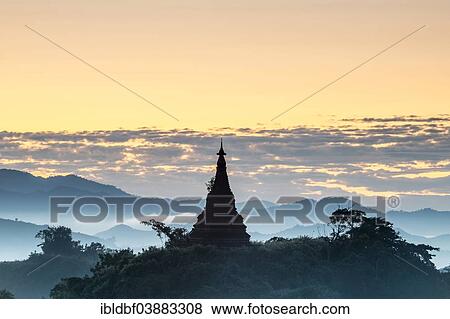 Stock Photo - "Pagoda surrounded by trees, in the mist, in the morning light, Mrauk U, Sittwe District, Rakhine State, Myanmar, Asia". Fotosearch