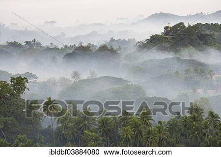 Stock Image - "Pagodas and temples surrounded by trees, in the mist, Mrauk U, Sittwe District, Rakhine State, Myanmar, Asia". Fotosearch