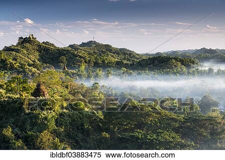 Stock Photography - "Pagodas surrounded by trees, in the mist, Mrauk U, Sittwe District, Rakhine State, Myanmar, Asia". Fotosearch