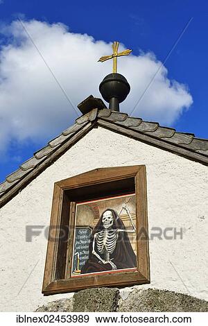 Stock Photo - "Painting or mural of a skeleton on the facade of a church, churchyard of the parish church of St. Sebastian, Berchtesgaden, Upper Bavaria, Bavaria, Germany, Europe". Fotosearch