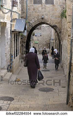 "Palestinian woman wearing a headscarf and students walking on an alley in the Arab district, Jerusalem, Israel, Asia, Middle East, Asia" View Large Photo Image Picture - "Palestinian woman wearing a headscarf and students walking on an alley in the Arab district, Jerusalem, Israel, Asia, Middle East, Asia". Fotosearch