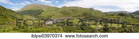 Picture - "Panoramic landscape of Glenfinnan Viaduct, arched railway bridge on West Highland Line, Lochaber, Scotland, United Kingdom, Europe". Fotosearch