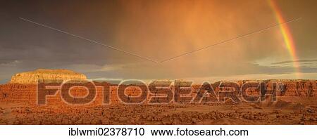Stock Image - "Panoramic view, rainbow during a thunderstorm, eroded hoodoos and Entrada Sandstone rock formations, Goblins, Goblin Valley State Park, San Rafael Reef Desert, Utah, Southwestern USA, USA". Fotosearch