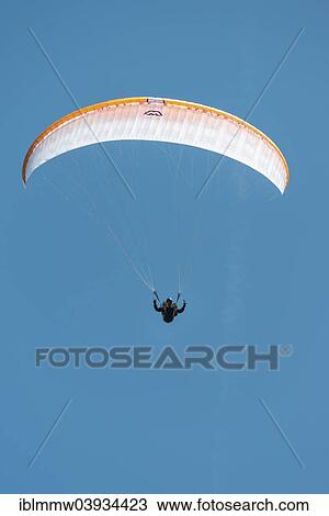 Stock Image - Paraglider against a blue sky. Fotosearch