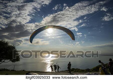Stock Image - "Paraglider at the start to a tandem jump, hang on Signal Hill, Cape Town, Western Cape, South Africa, Africa". Fotosearch