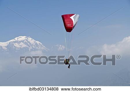 "Paraglider sailing through the air, Annapurna range in the back, Annapurna Region, Sarankot, Annapurna Region, Nepal, Asia" View Large Photo Image Stock Photo - "Paraglider sailing through the air, Annapurna range in the back, Annapurna Region, Sarankot, Annapurna Region, Nepal, Asia". Fotosearch