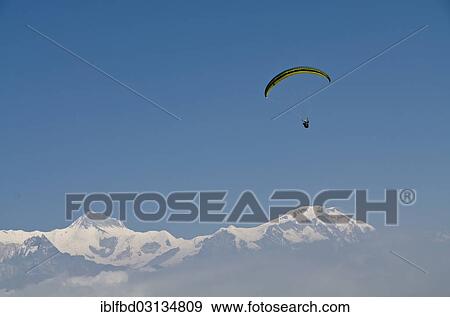 "Paraglider sailing through the air, Annapurna range in the back, Sarankot, Annapurna Region, Nepal, Asia" View Large Photo Image Stock Photo - "Paraglider sailing through the air, Annapurna range in the back, Sarankot, Annapurna Region, Nepal, Asia". Fotosearch