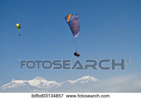 "Paraglider sailing through the air, Annapurna range in the back, Annapurna Region, Sarankot, Annapurna Region, Nepal, Asia" View Large Photo Image Stock Photo - "Paraglider sailing through the air, Annapurna range in the back, Annapurna Region, Sarankot, Annapurna Region, Nepal, Asia". Fotosearch