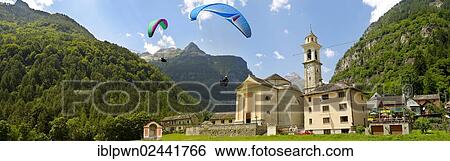 "Paragliders over the baroque church at Sonogno, Val Verzasca, Ticino, Swiss Alps, Switzerland, Europe" View Large Photo Image Stock Photograph - "Paragliders over the baroque church at Sonogno, Val Verzasca, Ticino, Swiss Alps, Switzerland, Europe". Fotosearch