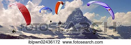 Stock Image - "Paragliders over the Matterhorn mountain peak, Swiss Alps, Switzerland, Europe". Fotosearch