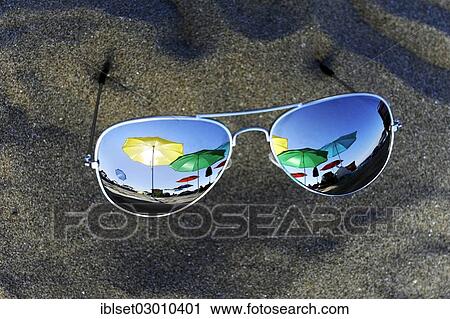 "Parasols are reflected in sunglasses lying in the sand, Cavallino, Jesolo, Venedig, Italy, Europe" View Large Photo Image Stock Image - "Parasols are reflected in sunglasses lying in the sand, Cavallino, Jesolo, Venedig, Italy, Europe". Fotosearch