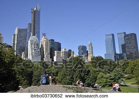 "Park visitors with apartment buildings on Central Park South, Manhattan, New York City, New York, United States, North America" View Large Photo Image Stock Image - "Park visitors with apartment buildings on Central Park South, Manhattan, New York City, New York, United States, North America". Fotosearch