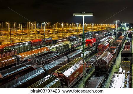 "Parked goods wagons on the tracks of the Maschen marshalling yard at night, Maschen, Lower Saxony, Germany, Europe" View Large Photo Image Stock Image - "Parked goods wagons on the tracks of the Maschen marshalling yard at night, Maschen, Lower Saxony, Germany, Europe". Fotosearch