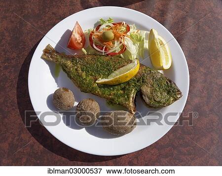 Stock Photo - "Parrot fish, fish meal in the Orquidea restaurant in La Calera, La Gomera, Valle Gran Rey, Canary Islands, Spain, Europe". Fotosearch