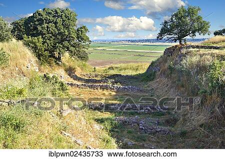 "Part of the Schliemann Trench excavated from 1871 with remains of the original walls and Bronze age house walls of Troy from the Early Troia I Period, c. 2920 B. C., Troy archaeological site, UNESCO World Heritage Site, Turkey, Asia" View Large Photo Image Stock Image - "Part of the Schliemann Trench excavated from 1871 with remains of the original walls and Bronze age house walls of Troy from the Early Troia I Period, c. 2920 B. C., Troy archaeological site, UNESCO World Heritage Site, Turkey, Asia". Fotosearch