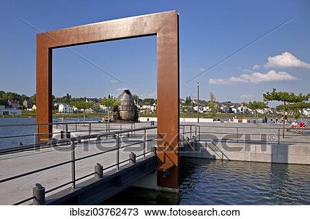 Stock Image - "Passage to Kulturinsel, cultural island with the Thomas-Konverter, preserved Thomas bulb, at Phoenix-See Lake, Horde, Dortmund, Ruhr district, North Rhine-Westphalia, Germany, Europe". Fotosearch