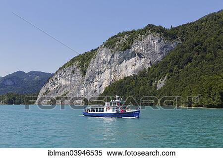 Stock Photography - "Passenger ship Zwoelferhorn in front of rock wall of Falkenstein, Lake Wolfgangsee, Salzkammergut, Salzburg State, Austria, Europe". Fotosearch
